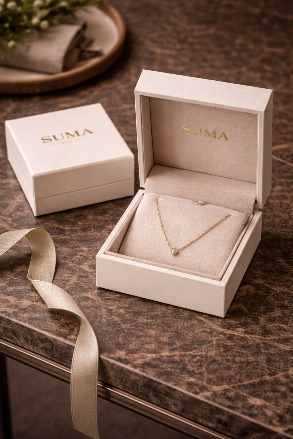 SUMA jewelry packaging with branded presentation box
