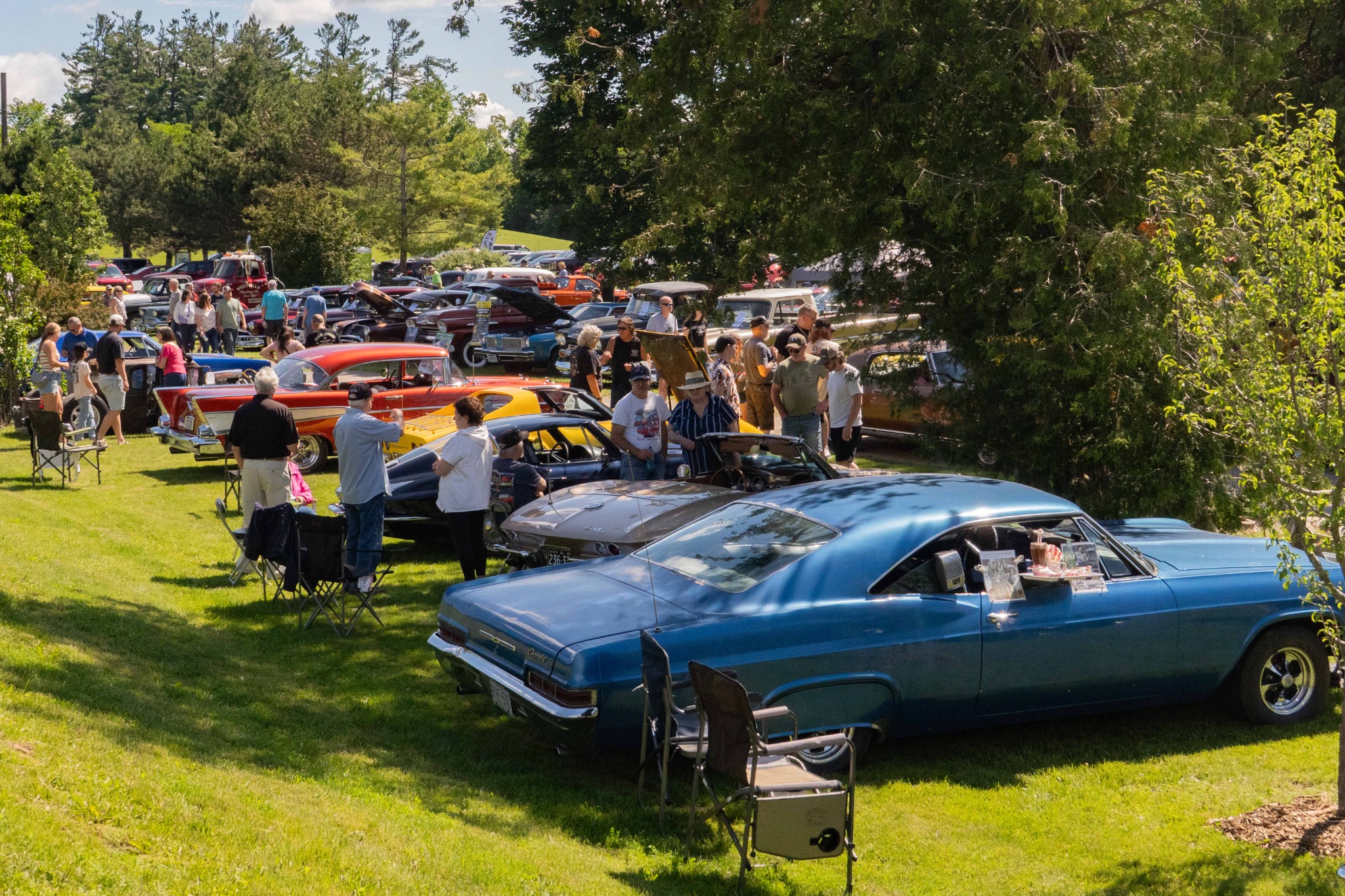 Wide view of classic cars and visitors at the Father’s Day Car Show
