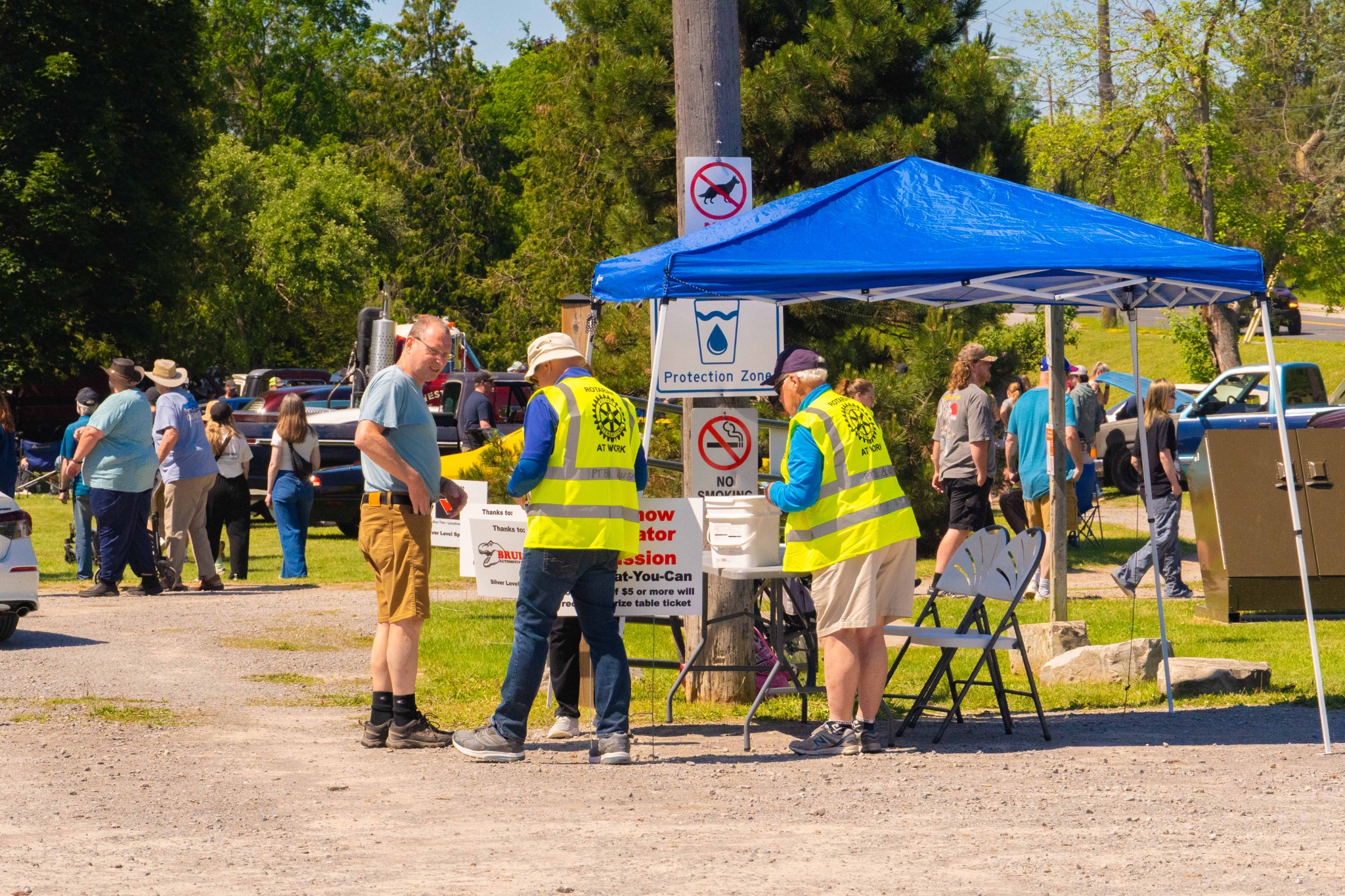 Visitors and volunteers near the entrance area of the Father’s Day Car Show