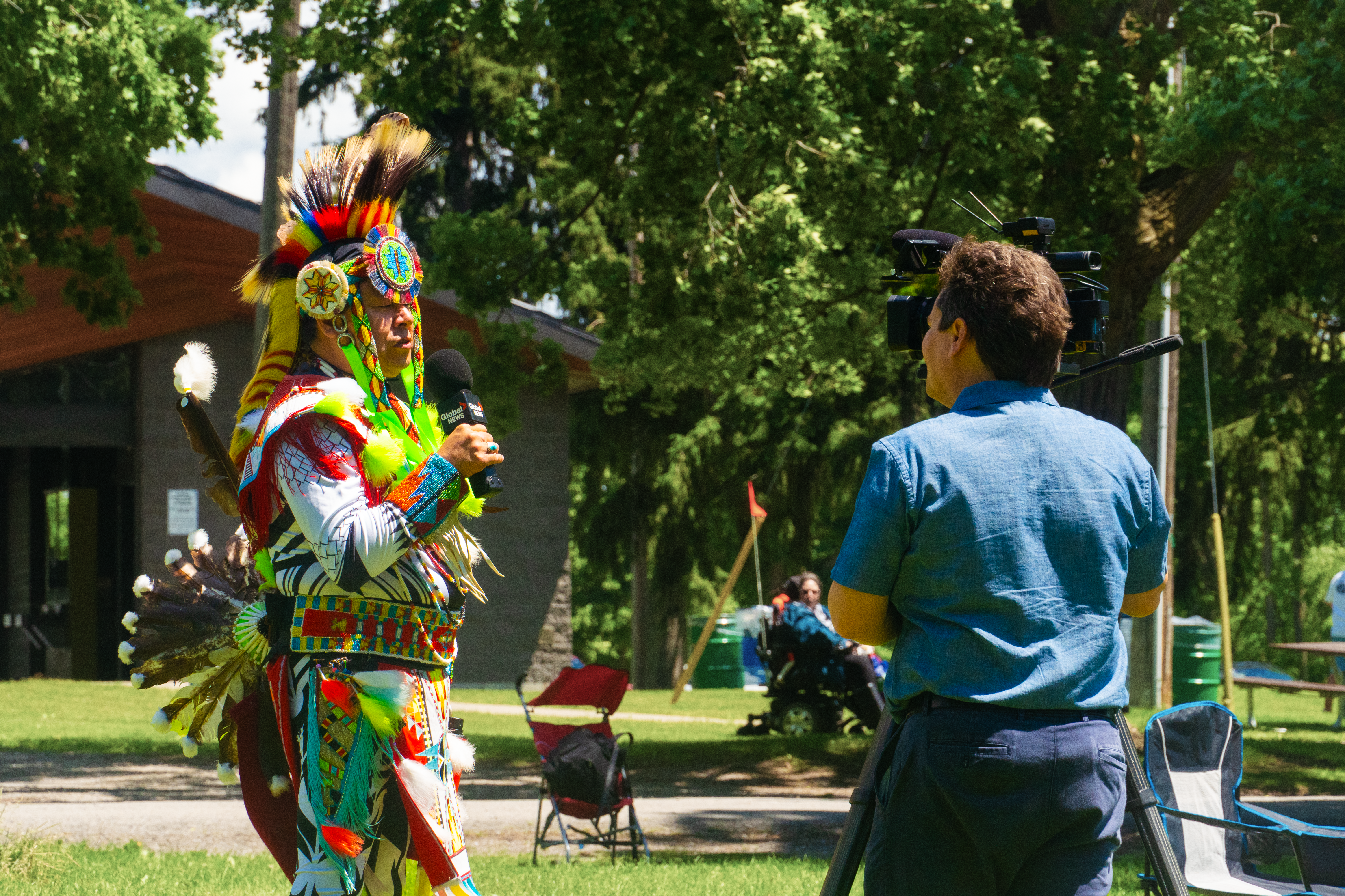 Indigenous participant in regalia speaking during National Indigenous Peoples Day
