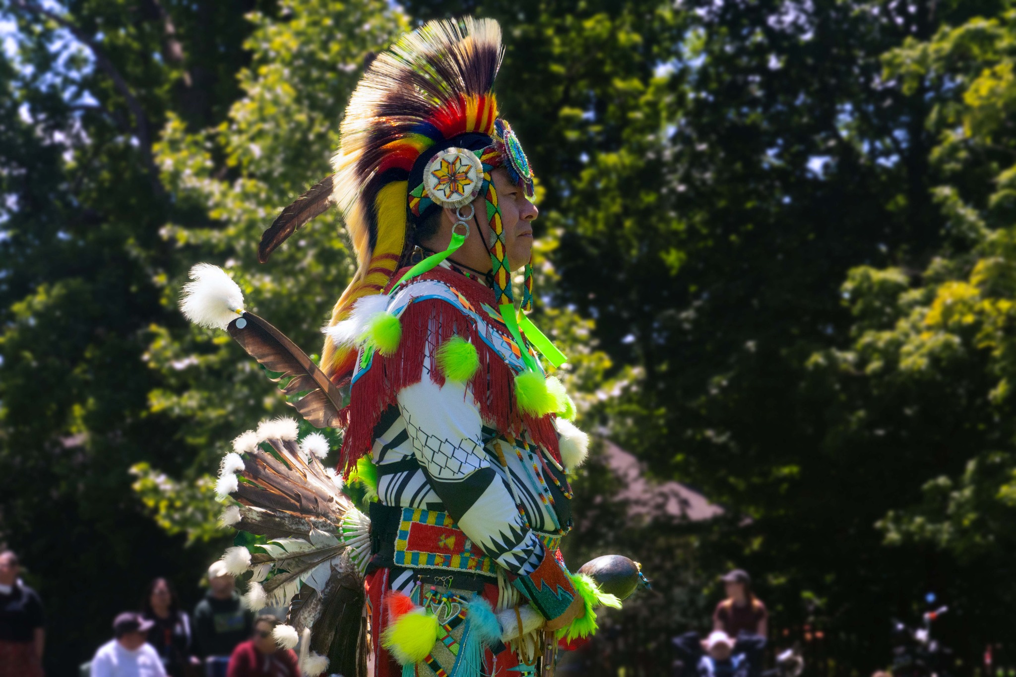 Indigenous dancer in colourful regalia at an outdoor community event